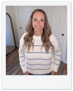 Sara wearing a blue-and-cream striped organic cotton crewneck sweater