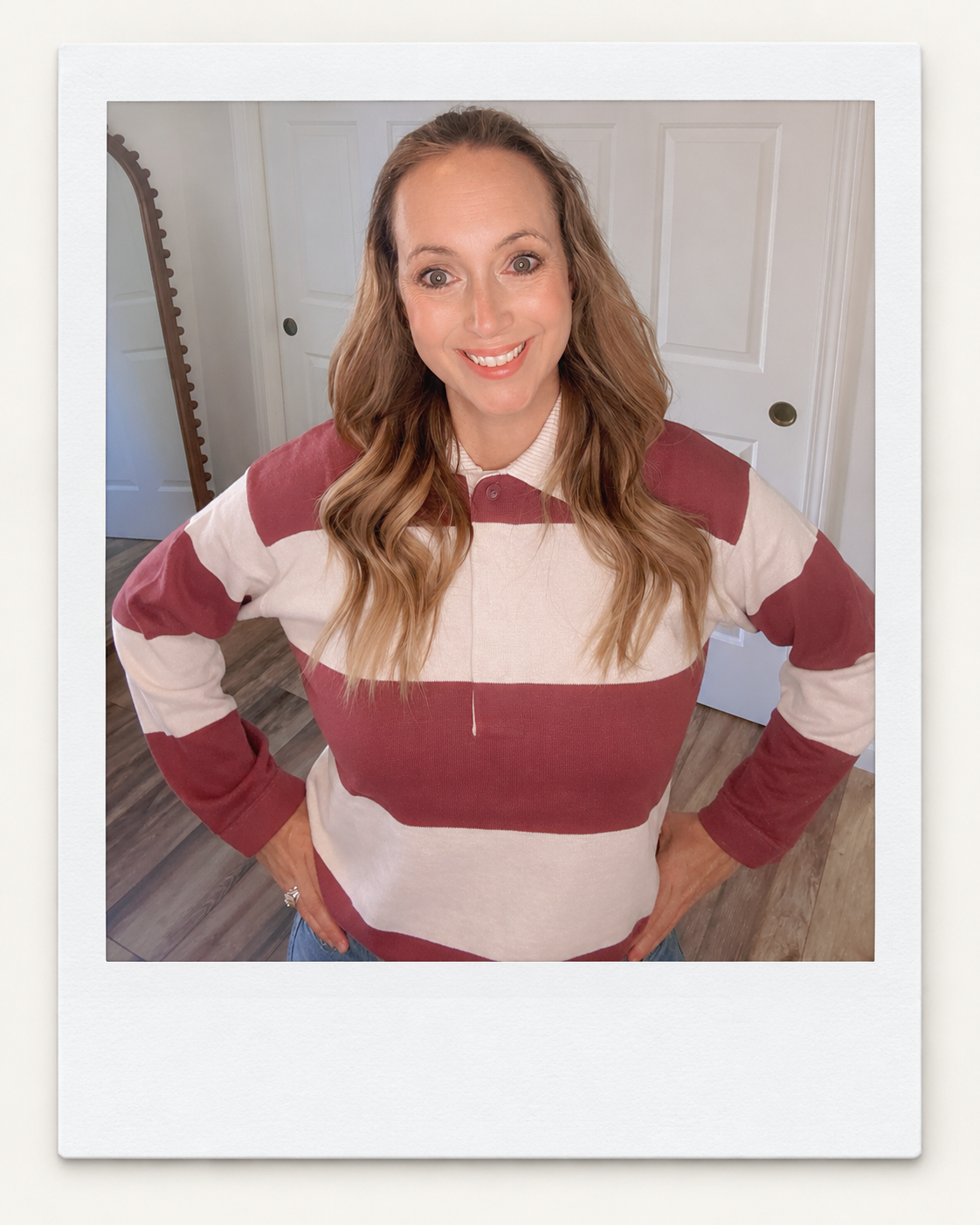 Sara wearing a muted berry rugby sweater with light-wash jeans